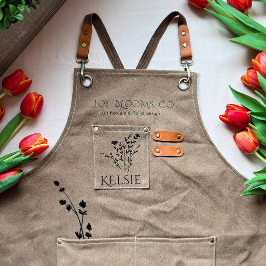 Florist apron with tool pockets worn for floral arranging in studio