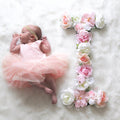 Faux silk floral initial letter cake table and event photo prop