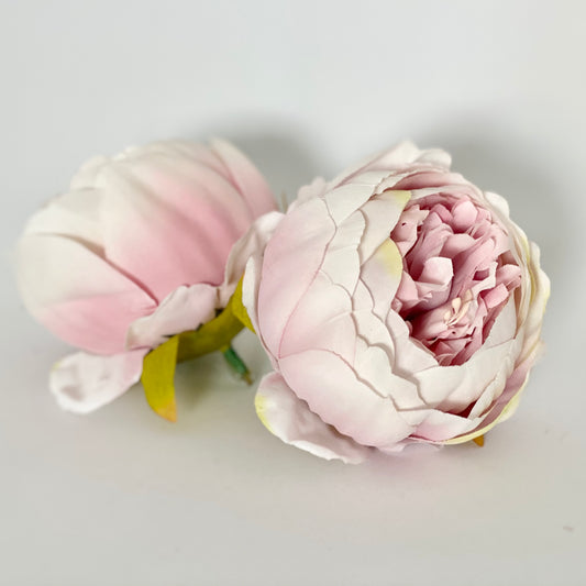 Blush pink and white faux peony heads close together