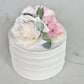 Custom floral cake topper on celebration cake