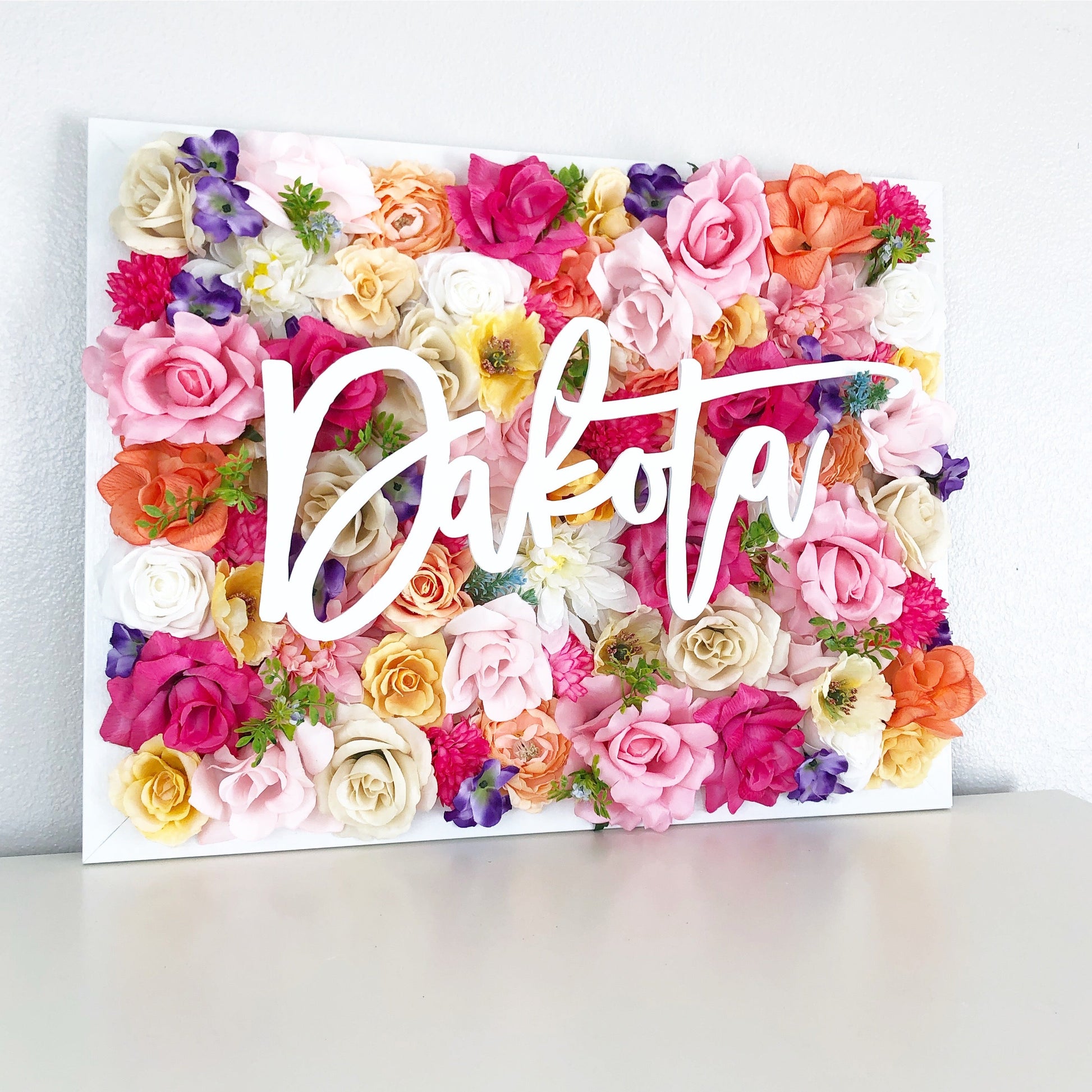 Hand placed 3D floral wall backdrop detail with name sign