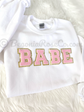 BABE patch sweatshirt flat lay showing grey colorway and cream white chenille patch
