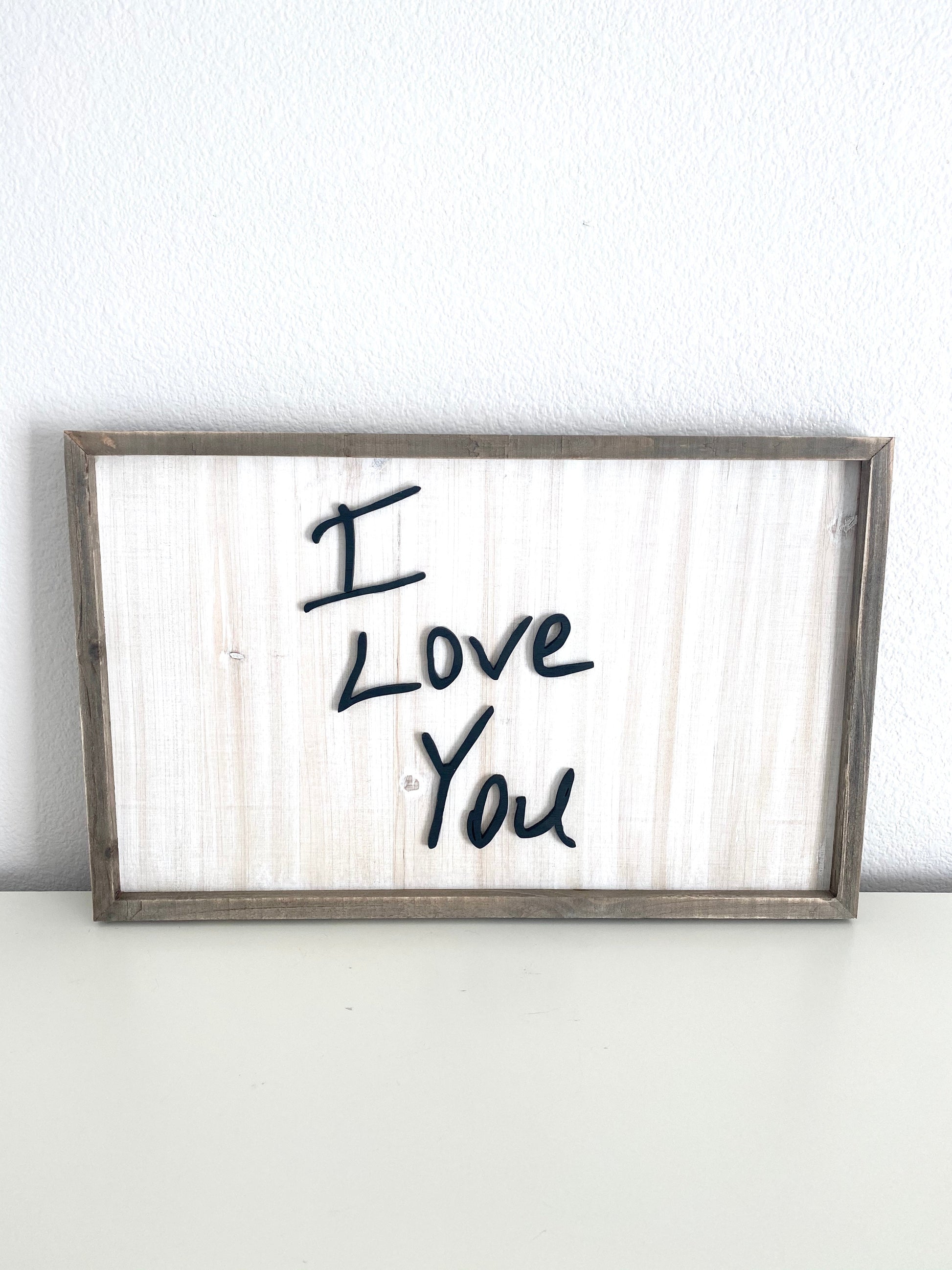 Framed laser cut wood sign with raised lettering