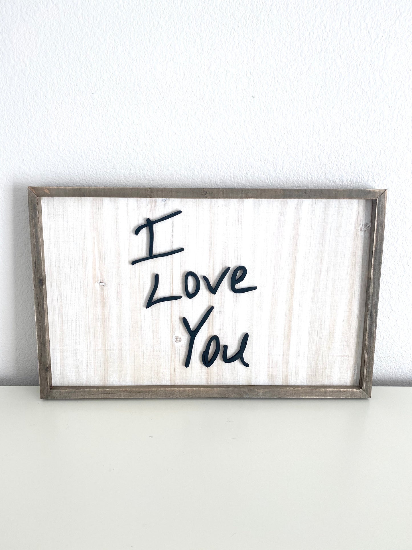 Framed laser cut wood sign with raised lettering