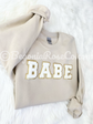 BABE patch sweatshirt front view showing elastic cuffs and waistband detail