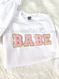 Chenille BABE patch crewneck sweatshirt in white with light pink letters - front view