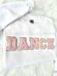 DANCE chenille patch crewneck sweatshirt flat lay in white with light pink patch