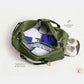 Open olive duffel showing wet and dry separation with shoes inside