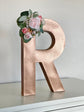 Gold handmade paper mache letter with flower accents party decor