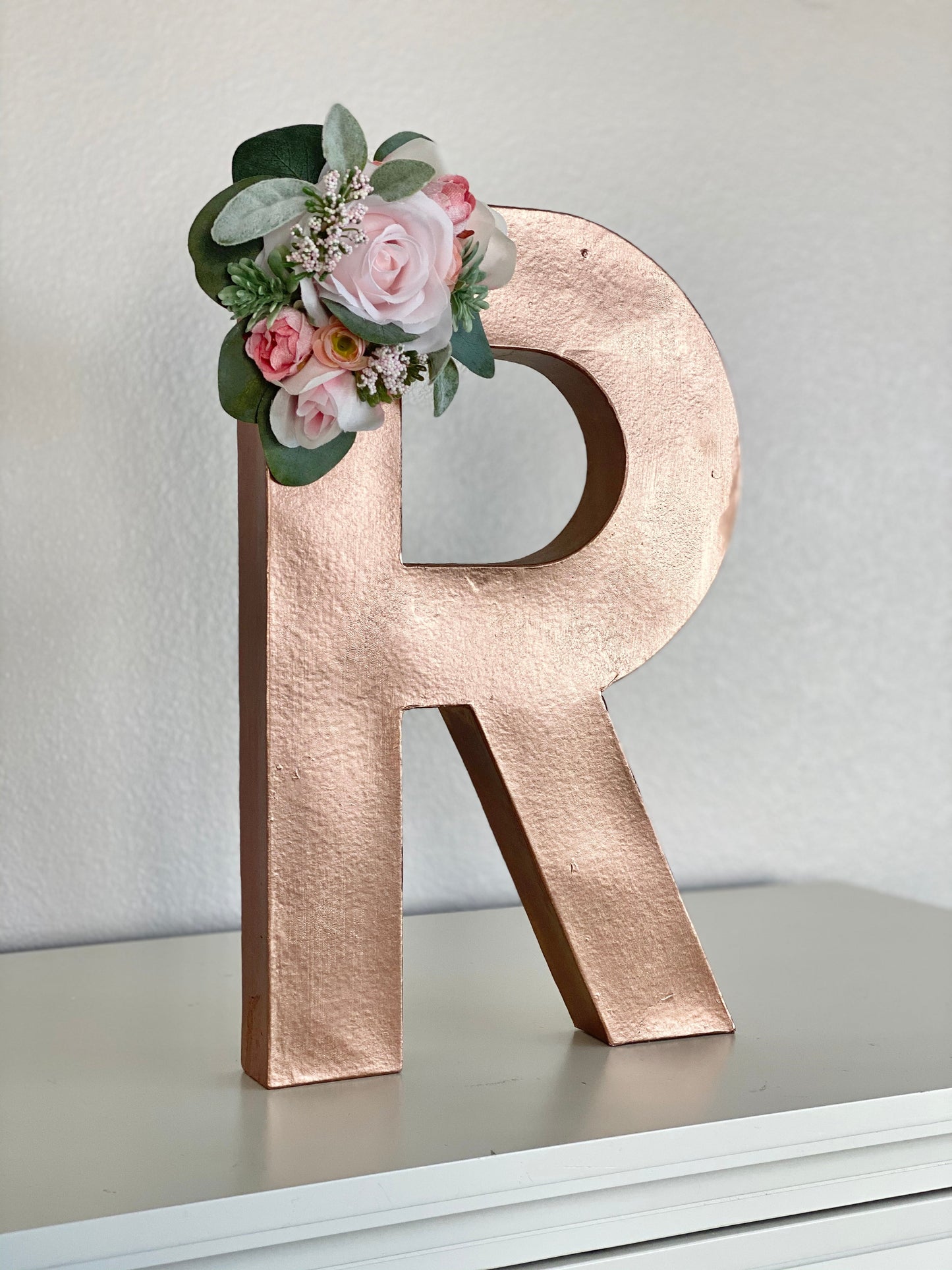 Gold handmade paper mache letter with flower accents party decor