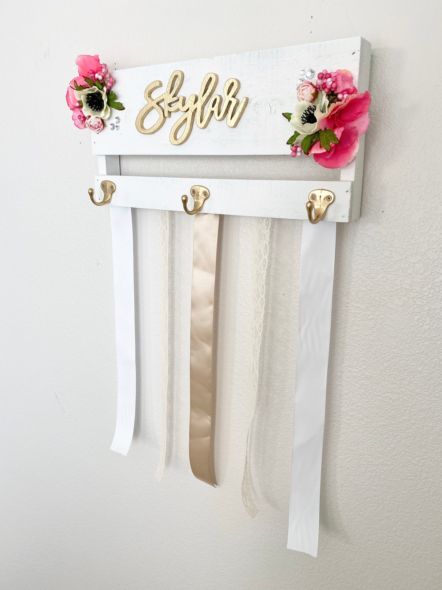Wood bow storage with custom name and floral embellishments
