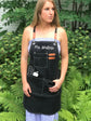 Teacher apron with pockets worn in classroom cross-back smock
