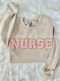 Chenille NURSE patch crewneck sweatshirt detail showing fluffy patch texture