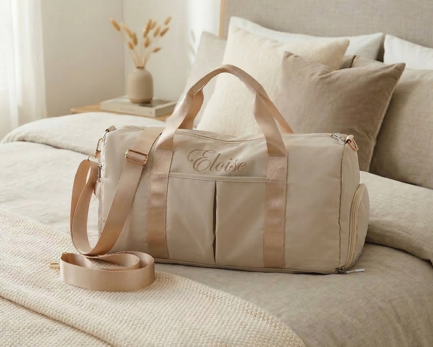Custom monogrammed weekender duffel bag with gold-tone hardware for travel