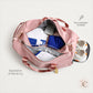Open pink weekender duffel showing wet and dry compartment separation with clothing and shoes inside