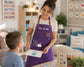 Teacher in a purple personalized apron with a custom name and students