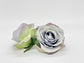 Single dusty blue faux rose close-up showing slate blue and grey petal detail