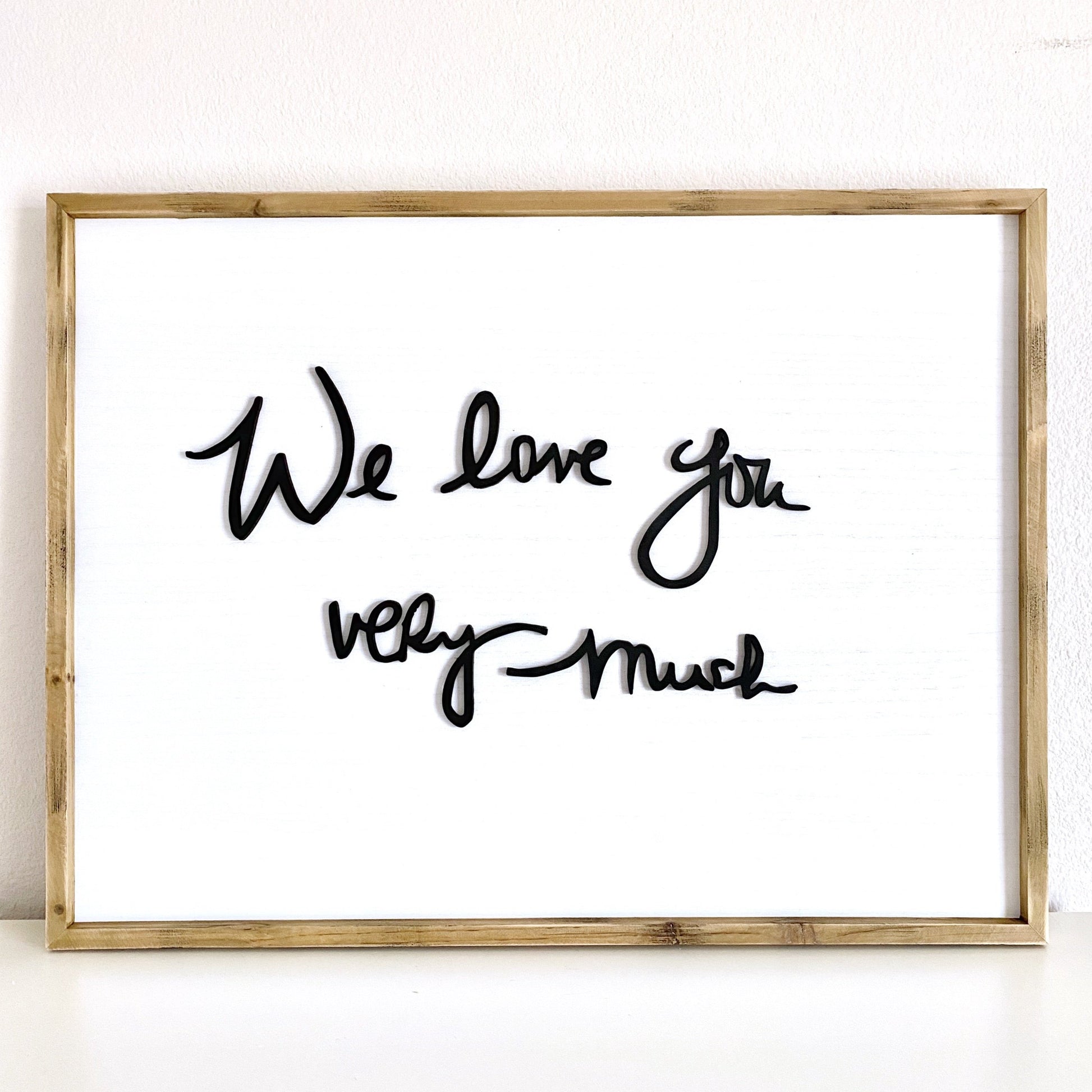 Laser cut handwriting sign detail - raised wood lettering on whitewashed background