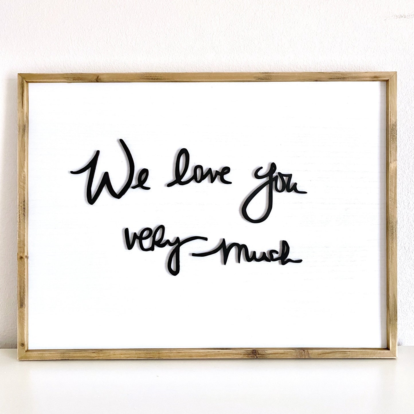 Laser cut handwriting sign detail - raised wood lettering on whitewashed background