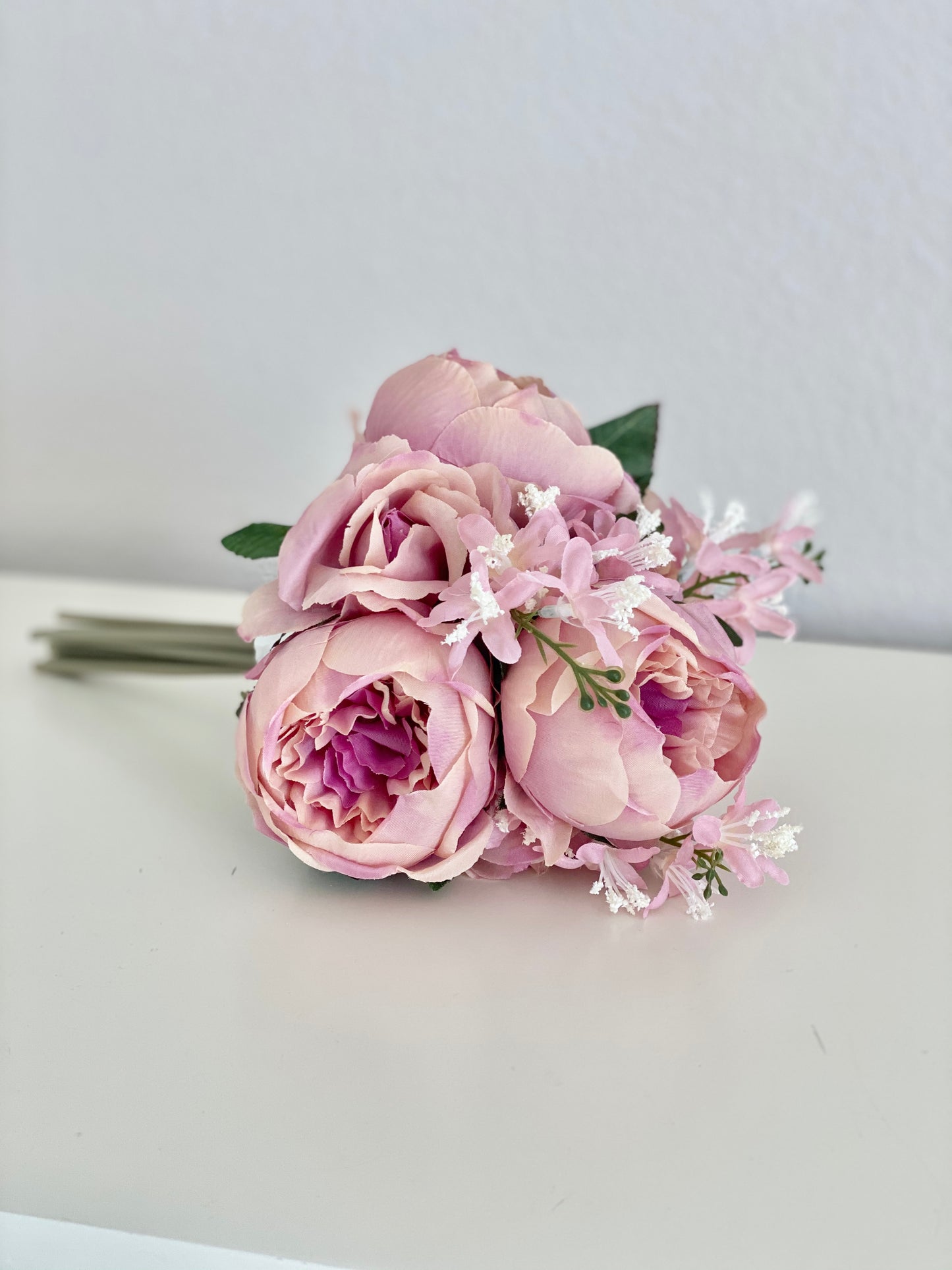 Two-tone pink peony faux bouquet overhead view for photo shoot and event styling